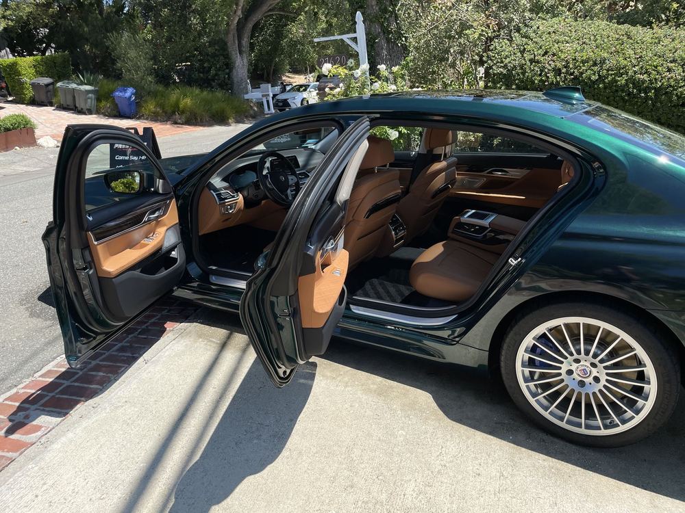 Green Bentley with door open showing interior